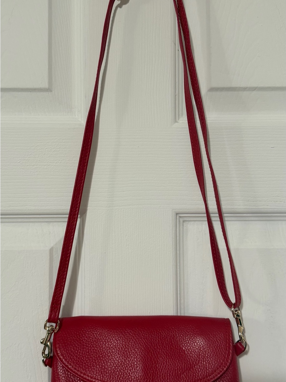 Sleek Red Pebbled Leather Crossbody Bag with Gold Accents